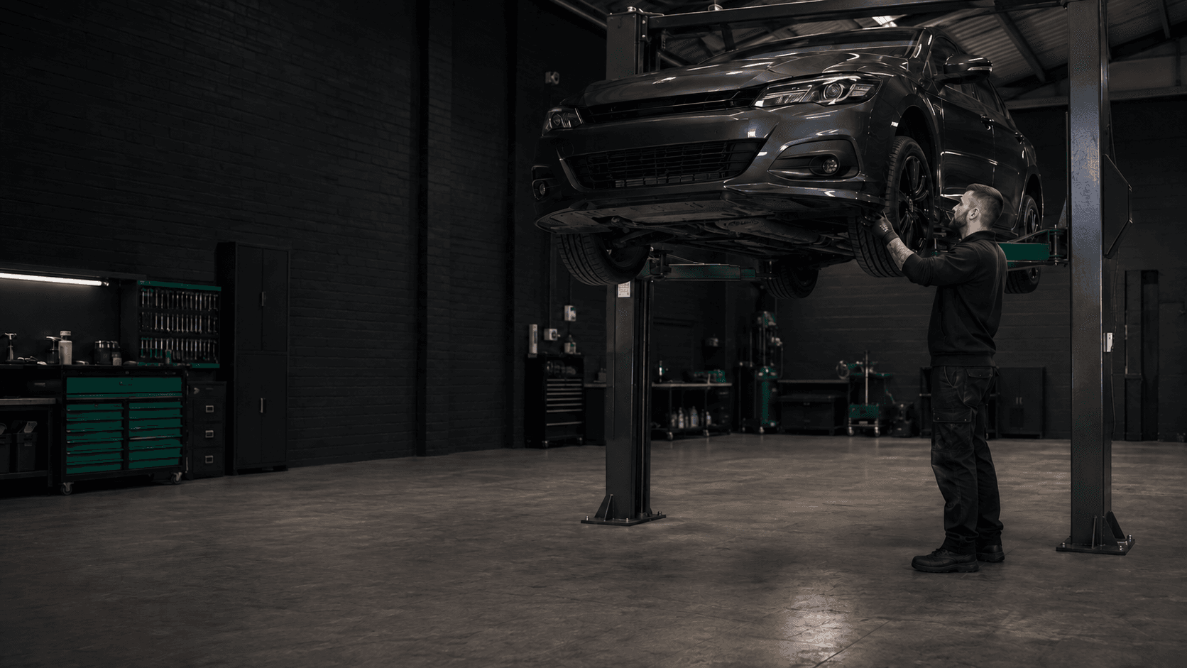 Modern independent car repair workshop with a vehicle on a lift